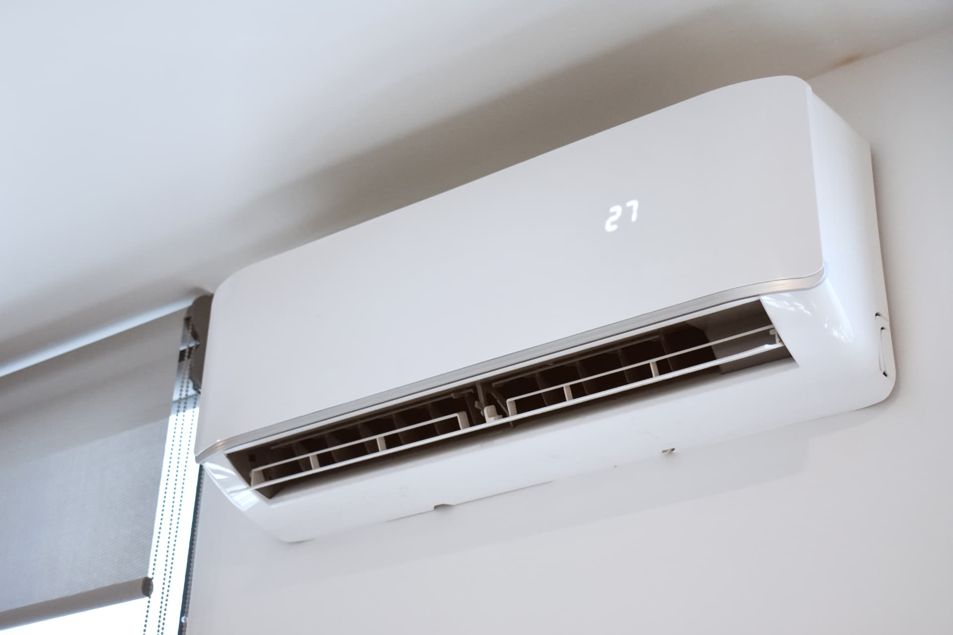 White ductless mini split indoor air handler mounted on a wall